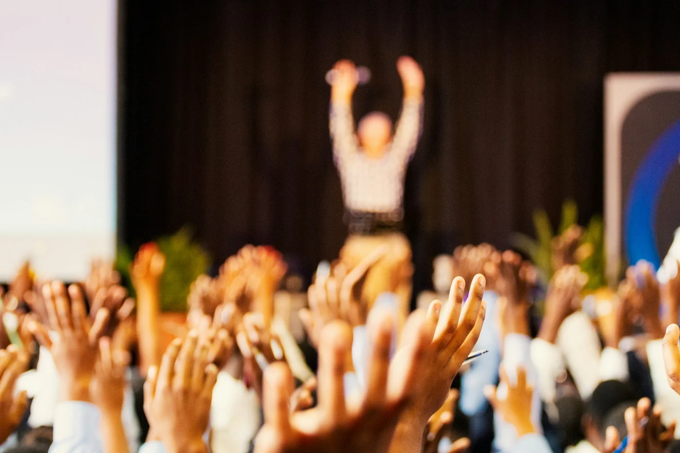 An audience in a conference room participates in an exchange